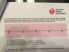 An 80-year-old woman presents to the emergency department with dizziness. She now states she is asymptomatic after walking around. Her blood pressure is 102/72 mm Hg. She is alert and oriented. Her lead II ECG is below. After you start an IV, what is the next action? An 80-year-old woman presents to the emergency department with dizziness. She now states she is asymptomatic after walking around. Her blood pressure is 102/72 mm Hg. She is alert and oriented. Her lead II ECG is below. After you start an IV, what is the next action?