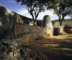 Concial tower and circular wall of Great Zimbabwe
South Zimbabwe, Shona Peoples, 1000-1400, Granite blocks
Zimbabwe derives from Shona term meaning venerated house or house of stone
Prosperous trading center and royal complex
Stone enclosure, probly royal residence
Walls 800ft long, 32 ft tall, 17 ft thick at the base
Conical tower modeled on traditional shapes of grain silos, control over food symbolized wealth/power
Wall slope inwards at the top
Passageways very narrow/long so single file line necessary
Tower resembles granery representing good harvest Concial tower and circular wall of Great Zimbabwe
South Zimbabwe, Shona Peoples, 1000-1400, Granite blocks
Zimbabwe derives from Shona term meaning venerated house or house of stone
Prosperous trading center and royal complex
Stone enclosure, probly royal residence
Walls 800ft long, 32 ft tall, 17 ft thick at the base
Conical tower modeled on traditional shapes of grain silos, control over food symbolized wealth/power
Wall slope inwards at the top
Passageways very narrow/long so single file line necessary
Tower resembles granery representing good harvest