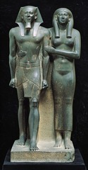 King Menkaura and Queen
Old Kingdom, 2490-2472 B.C.E.
Greywacke
Figures carved from block of stone, arms/legs not free, no open space between body
Rigid frontal pose with left food proceeding
Staring out into space
Wife holding him, presenting him to the gods
Menkaura shown with strong physique showing how powerful of a king he was
Gender equality as both figures same height King Menkaura and Queen
Old Kingdom, 2490-2472 B.C.E.
Greywacke
Figures carved from block of stone, arms/legs not free, no open space between body
Rigid frontal pose with left food proceeding
Staring out into space
Wife holding him, presenting him to the gods
Menkaura shown with strong physique showing how powerful of a king he was
Gender equality as both figures same height