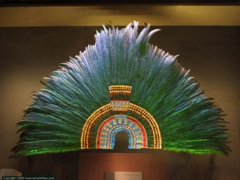 Ruler's feather headdress (probably of Motecuhzoma II)
Mexica (Aztec). 1428-1520 C.E. Feathers (quetzal and cotinga) and gold
He headdress was probably part of the collection of artefacts given by Motecuhzoma to Cortés who passed on the gifts to Charles V. The headdress is made from 450 green quetzal, blue cotinga and pink flamingo feathers and is further embellished with gold beads and jade disks. Ruler's feather headdress (probably of Motecuhzoma II)
Mexica (Aztec). 1428-1520 C.E. Feathers (quetzal and cotinga) and gold
He headdress was probably part of the collection of artefacts given by Motecuhzoma to Cortés who passed on the gifts to Charles V. The headdress is made from 450 green quetzal, blue cotinga and pink flamingo feathers and is further embellished with gold beads and jade disks.
