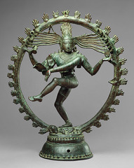 Shiva as Lord of Dance
Hindu, India, Chola Dynasty, 11th century, Cast bronze
Vigorously dancing with one foot on dwarf, Demon of Ignorance, often depicted in a flaming nimbus
flying locks of hair terminate in rearing cobra hands
one hand sounds the drum that he dances to another has a flame
Ring of fire surrounding him is the encapsulated universe with endless cycle of periodically destroying the universe so it can be reborn again, moves in tune with the dance
Lower right hand in gesture saying not to be afraid
unfolds universe out of the drum held in one of his right hands,
Shiva has a third vertical eye suggested between his two other eyes
Face stays tranquil despite scene of chaos Shiva as Lord of Dance
Hindu, India, Chola Dynasty, 11th century, Cast bronze
Vigorously dancing with one foot on dwarf, Demon of Ignorance, often depicted in a flaming nimbus
flying locks of hair terminate in rearing cobra hands
one hand sounds the drum that he dances to another has a flame
Ring of fire surrounding him is the encapsulated universe with endless cycle of periodically destroying the universe so it can be reborn again, moves in tune with the dance
Lower right hand in gesture saying not to be afraid
unfolds universe out of the drum held in one of his right hands,
Shiva has a third vertical eye suggested between his two other eyes
Face stays tranquil despite scene of chaos