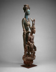 Veranda post of enthroned king and senior wife
Yoruba People, 1910, Wood/pigment
Yoruba peoples carved posts for ruler of their kingdom in Nigeria
One of 4 posts made for the palace at Ikere
Negative space creates an
openness in composition
King is focal point in relationship between his wife and others represented on post
Behind him his large scale senior wife supports the throne
She crows the king during the coronation, protects him during his reign Veranda post of enthroned king and senior wife
Yoruba People, 1910, Wood/pigment
Yoruba peoples carved posts for ruler of their kingdom in Nigeria
One of 4 posts made for the palace at Ikere
Negative space creates an
openness in composition
King is focal point in relationship between his wife and others represented on post
Behind him his large scale senior wife supports the throne
She crows the king during the coronation, protects him during his reign
